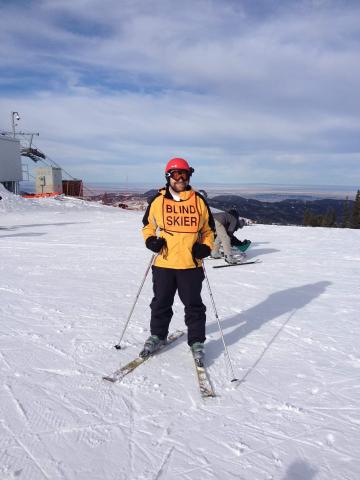 Jesse at the top of Terry peak in SD wearing blind skier vest.